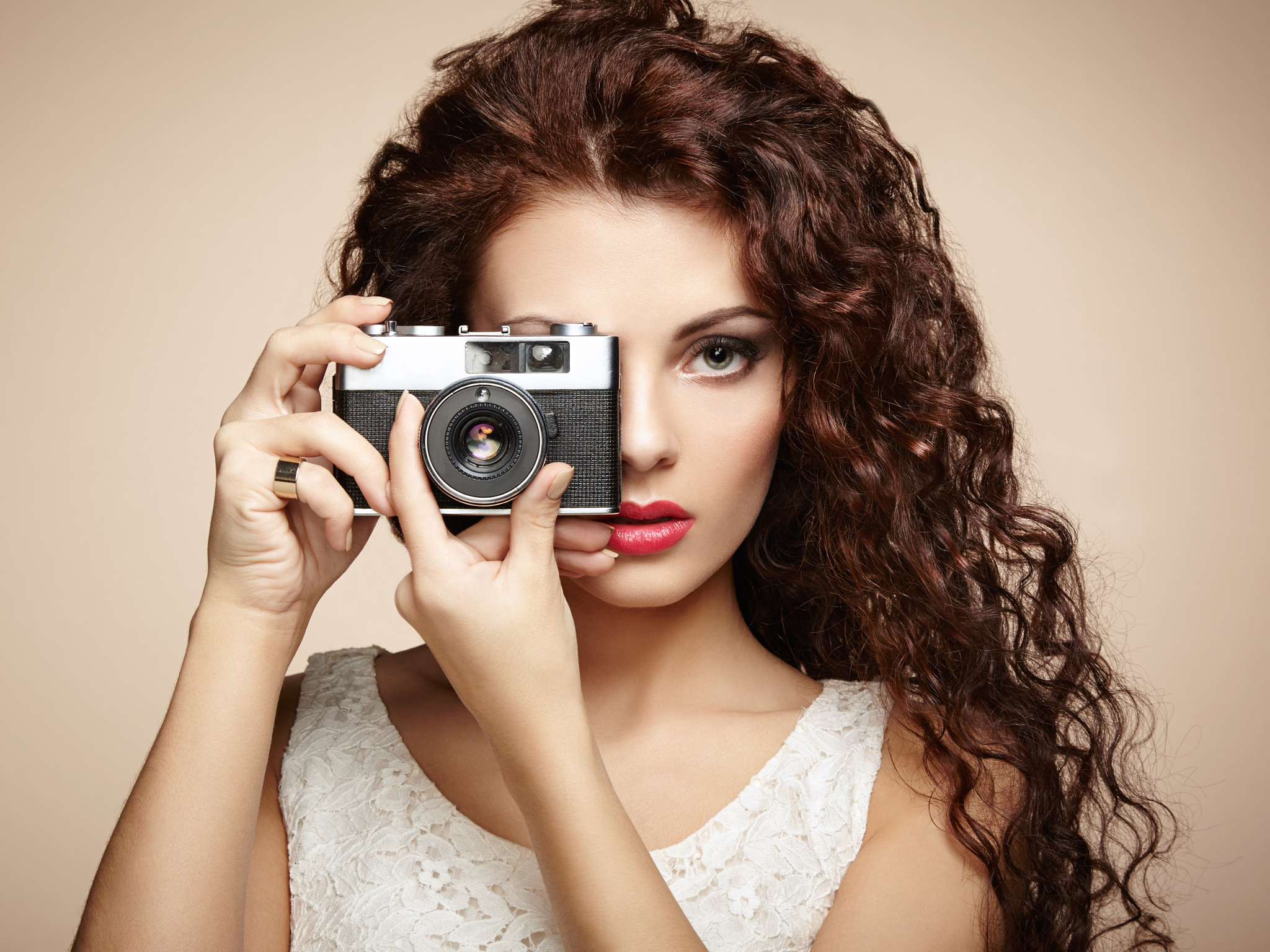 Portrait of beautiful woman with the camera. Girl photographer